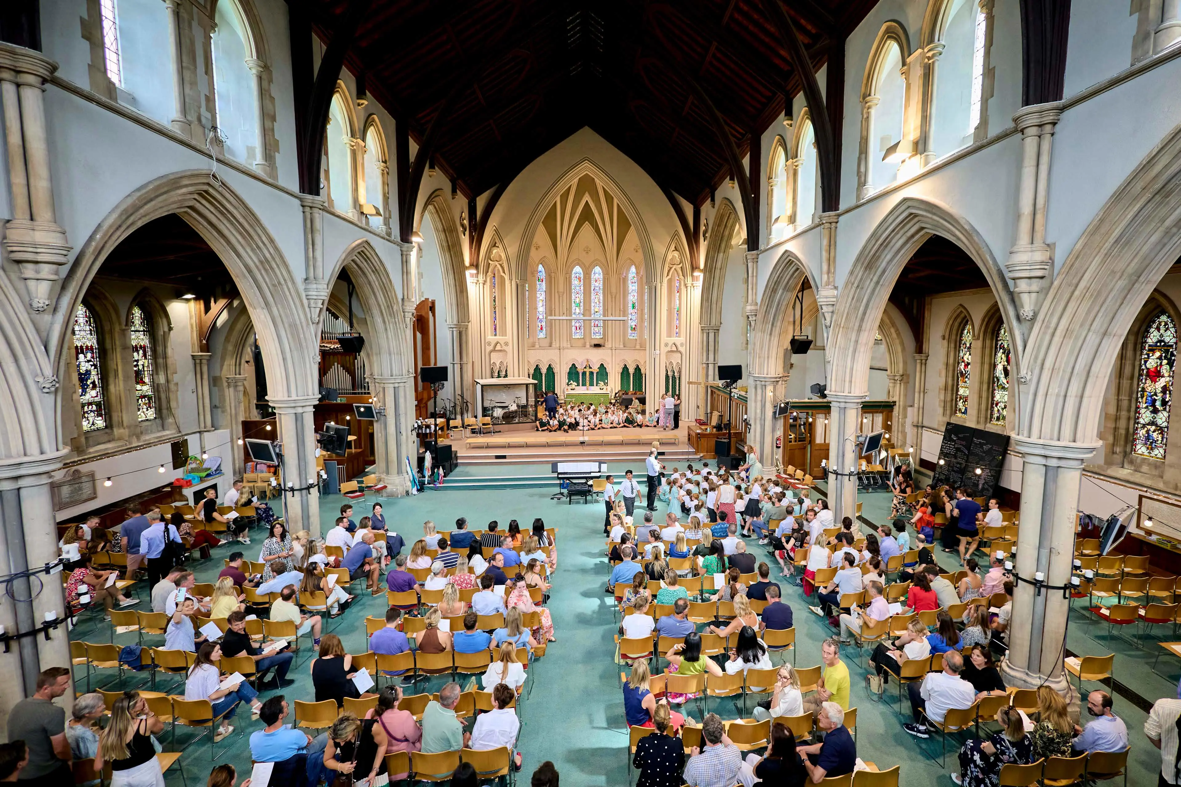 nterior of Christ Church, Clifton during a Clifton High School celebration event with pupils, families and staff gathered inside the historic church.