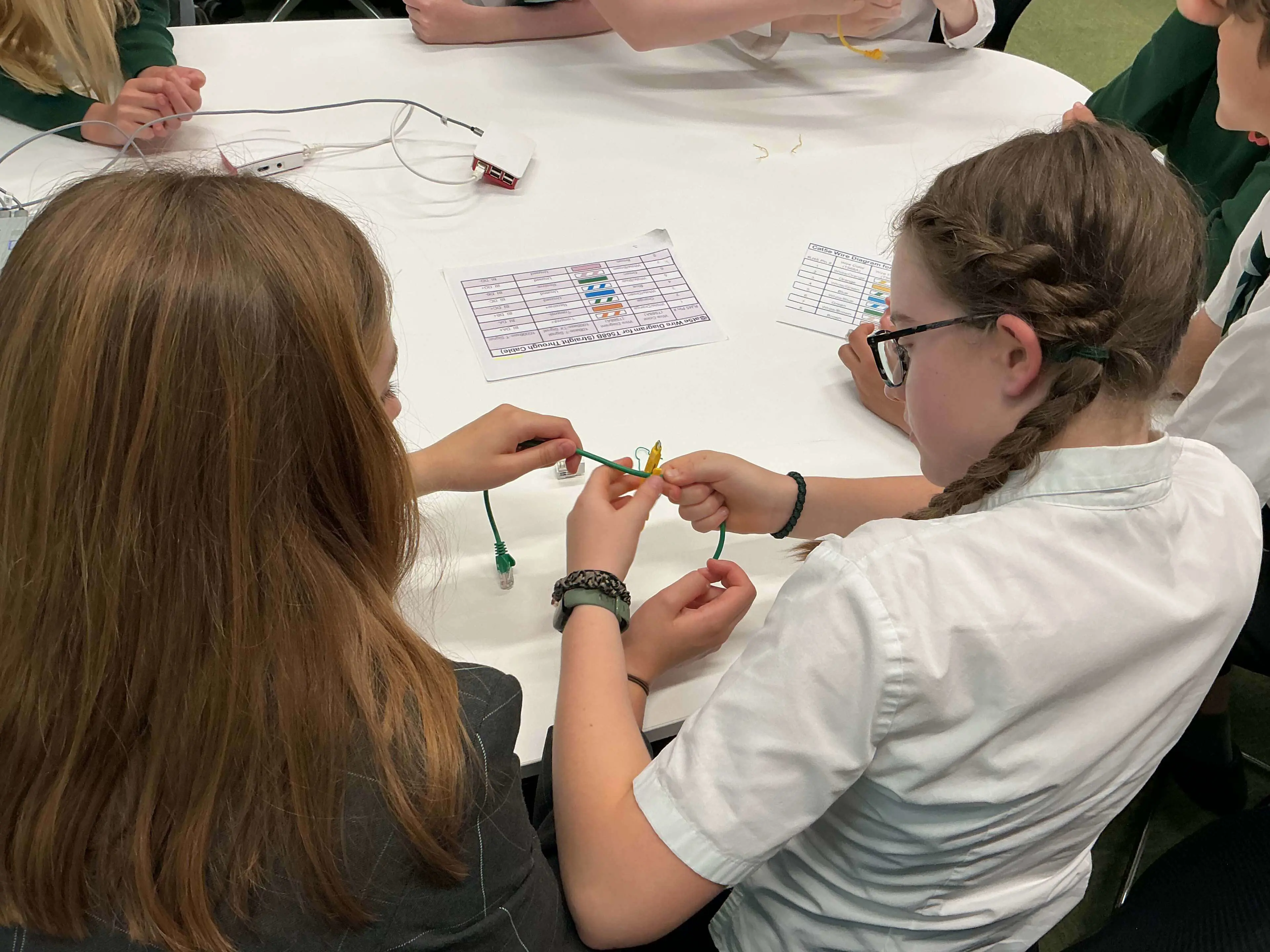 Clifton High School Senior School pupils taking part in a hands-on cybersecurity activity at the Unlock Cyber Taster Day 2026, working together to connect network cables and complete a practical STEM 