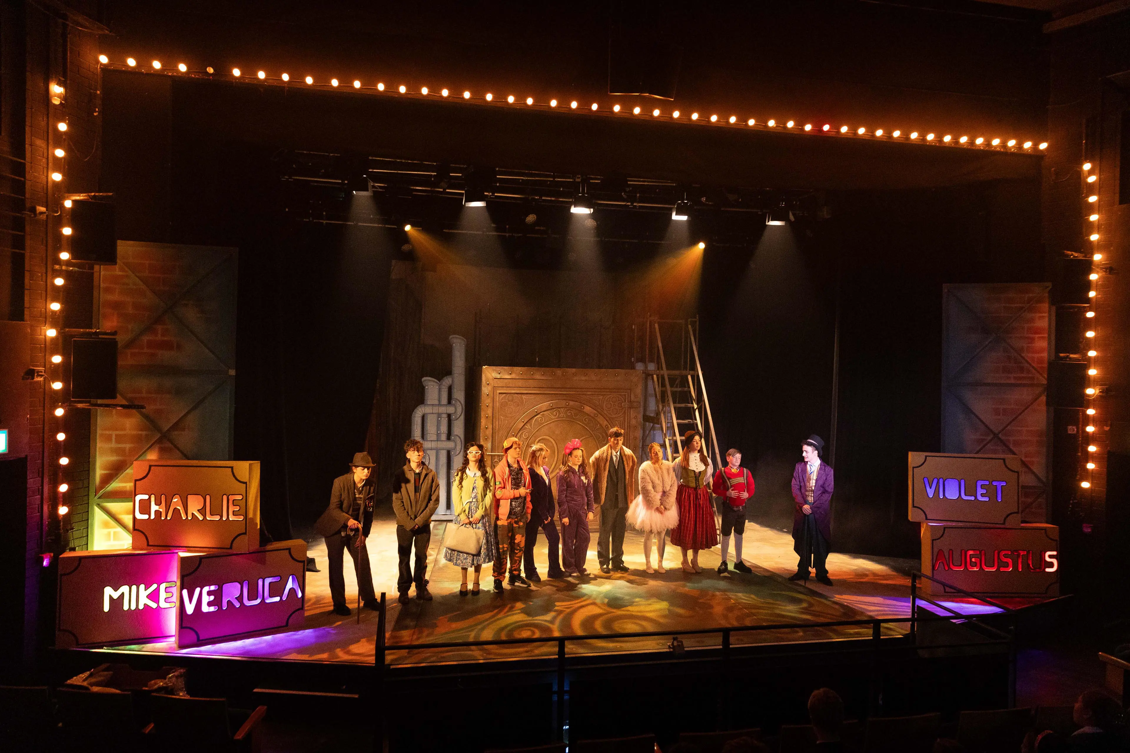 Performance of Charlie and the Chocolate Factory on stage at The Redgrave Theatre at Clifton High School.