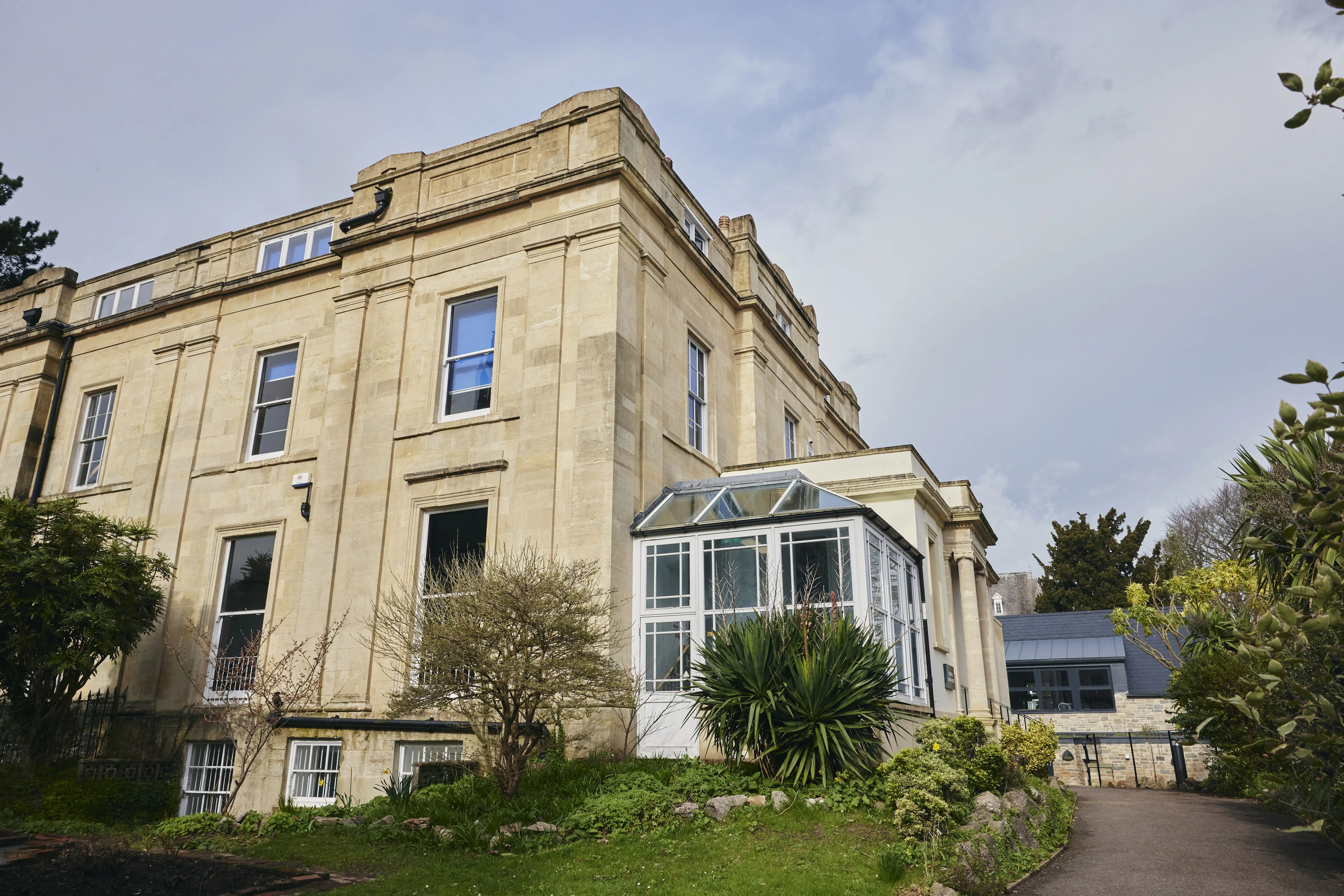 Exterior view of Walter's Sixth Form Centre at Clifton High School, showing the historic building and landscaped grounds.
