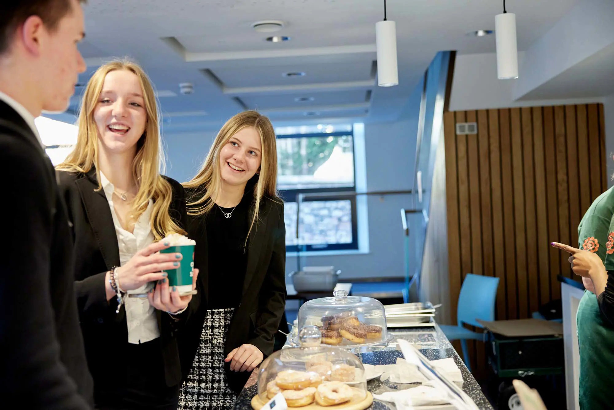 Sixth Form students at Dawn's Café in Walter's Sixth Form Centre at Clifton High School enjoying refreshments in a relaxed social space.